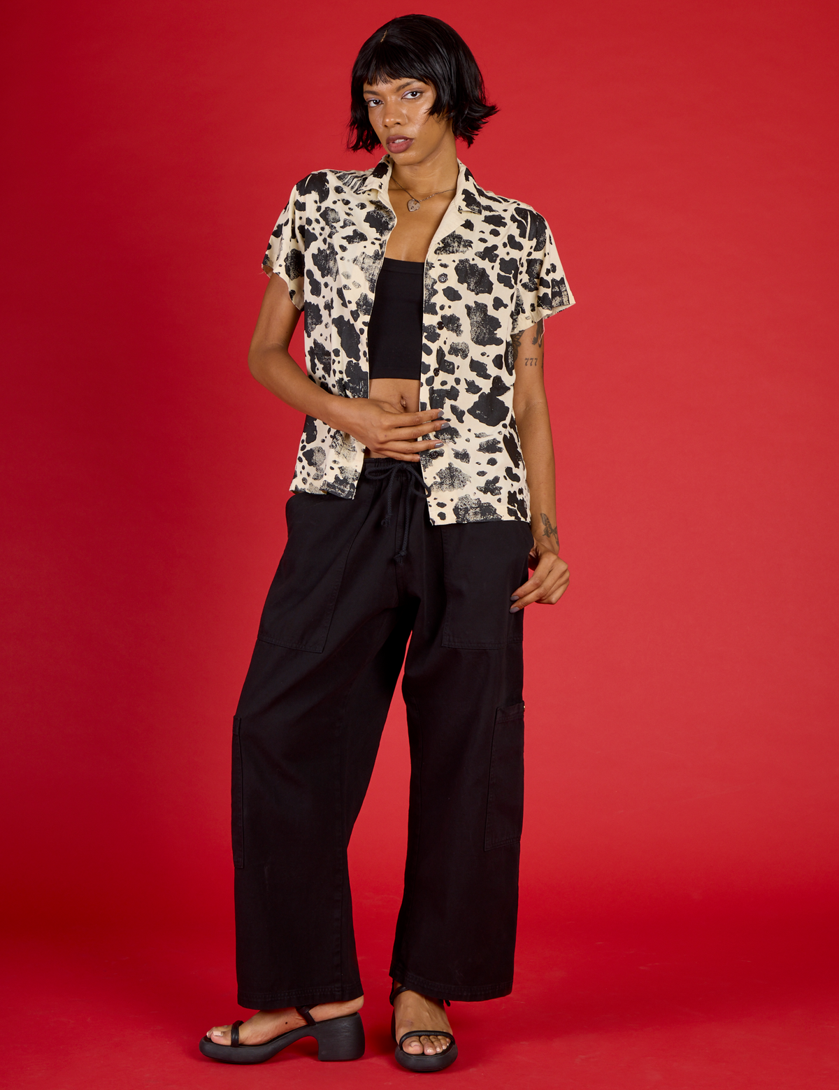 Kira wearing the Cow Pantry Button Up with the Black Cropped Tank and Black Drop Pocket Pants