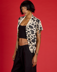 Angled side view of Kira wearing the Cow Pantry Button Up