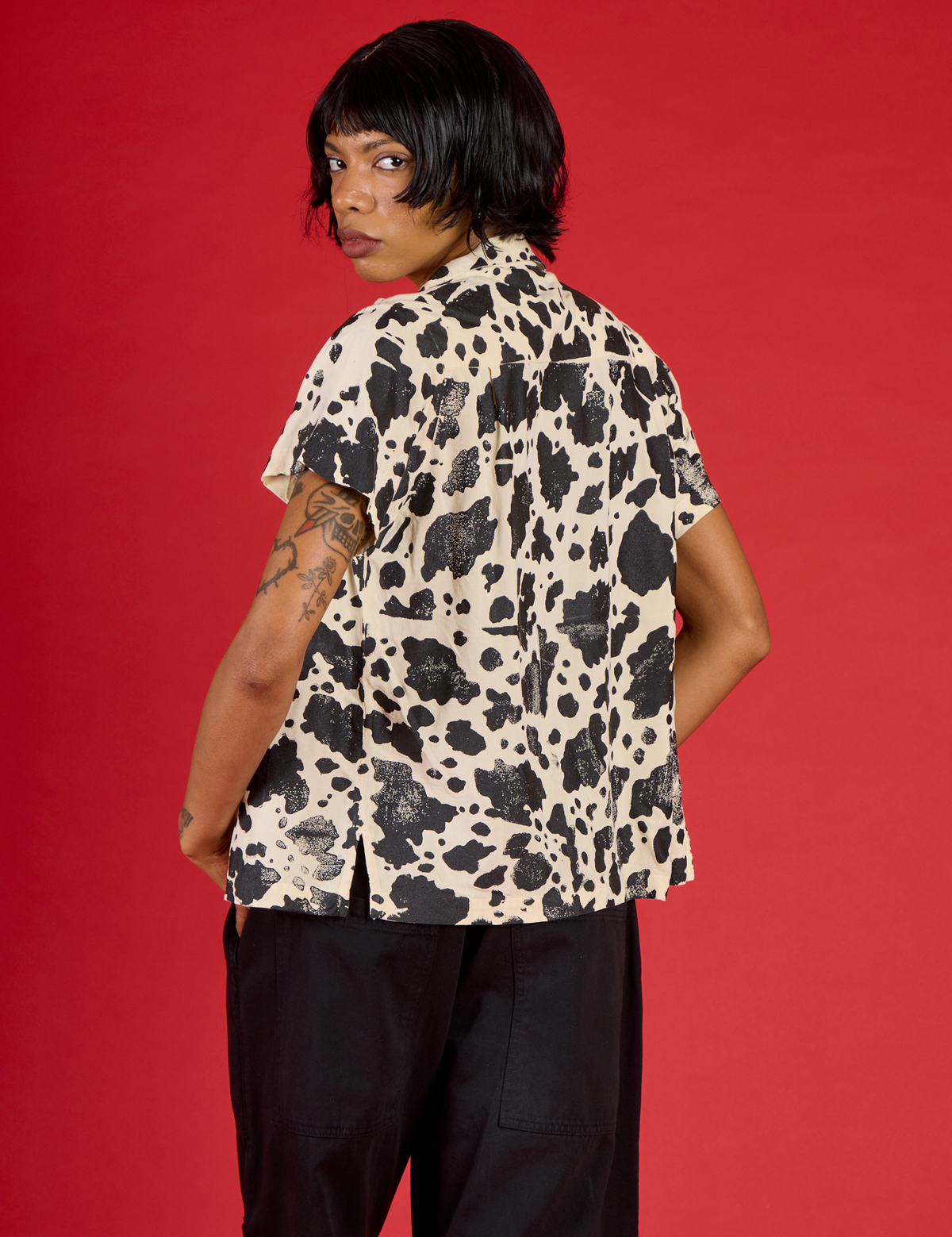 Angled back view of the Cow Pantry Button Up on Kira