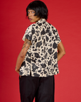 Angled back view of the Cow Pantry Button Up on Kira
