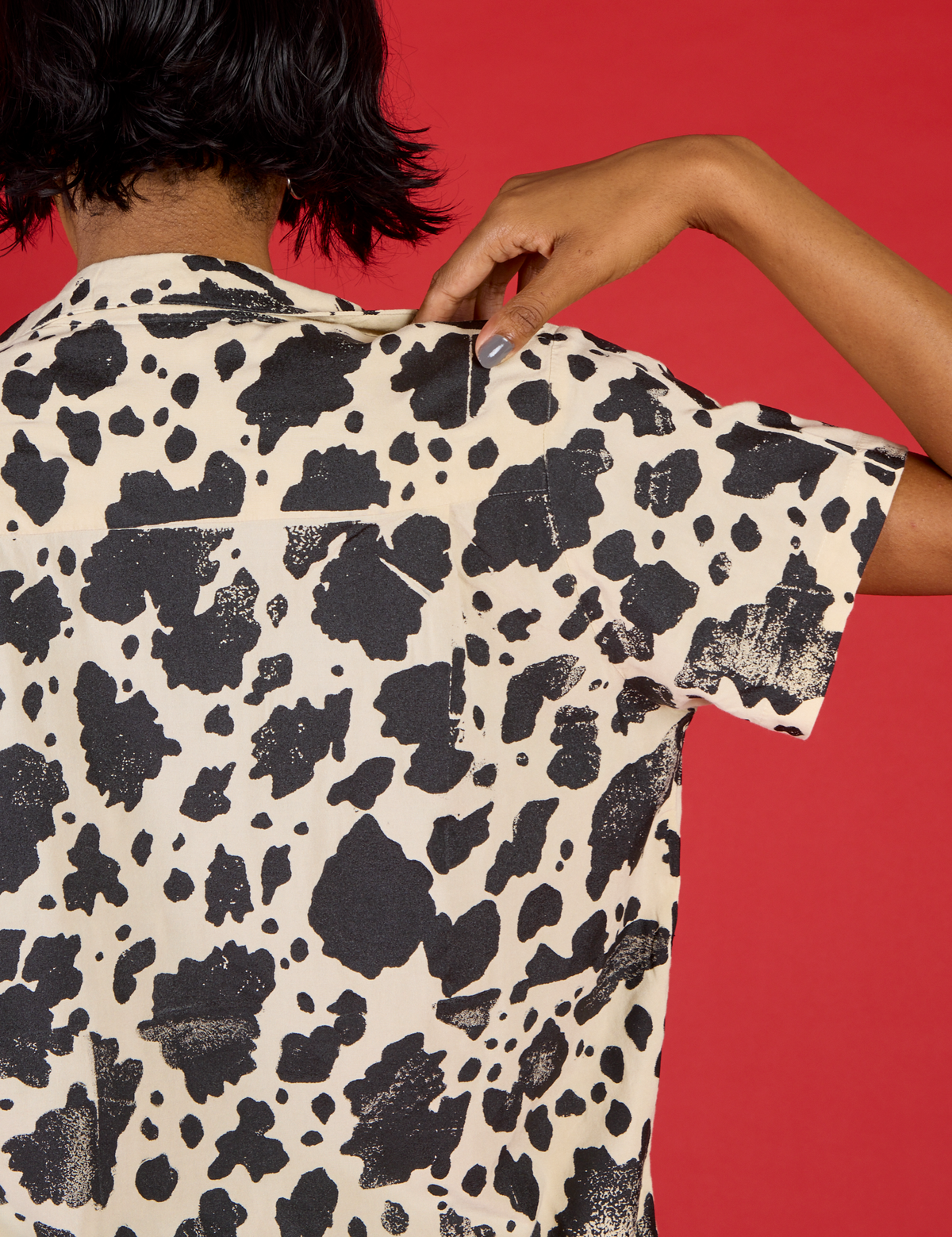 Close up back view of the Cow Pantry Button Up on Kira