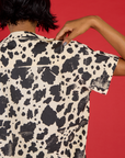 Close up back view of the Cow Pantry Button Up on Kira