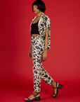 Angled side view of Kira wearing the Cow Work Pant with the Cow Pantry Button up