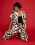 Kira wearing the Cow Pantry Button Up open with the Black Cropped Tank and matching Cow Work Pant