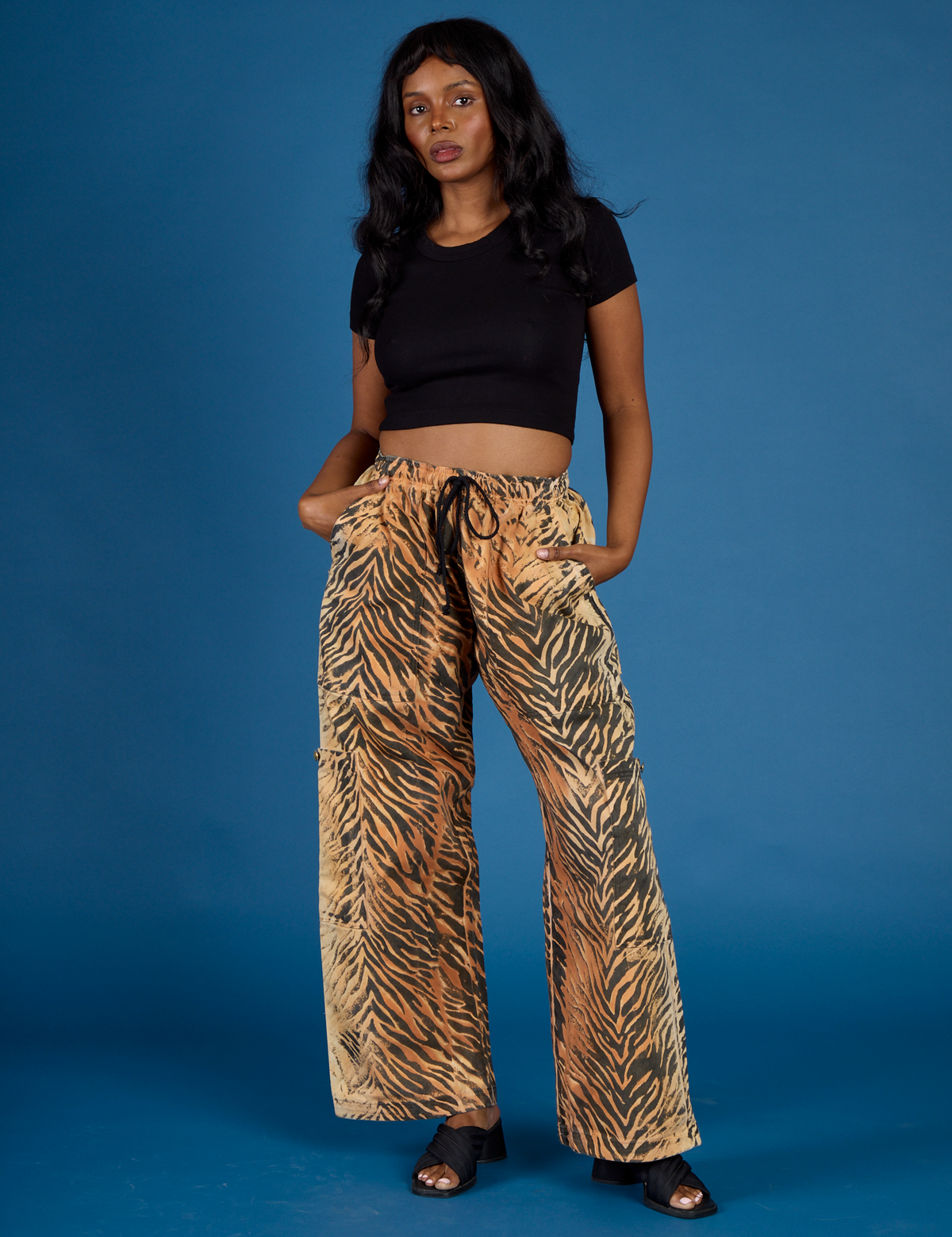 Kandia is 5'3" and wearing XS Tiger Drop Pocket Pant with the Black Cropped Baby Tee
