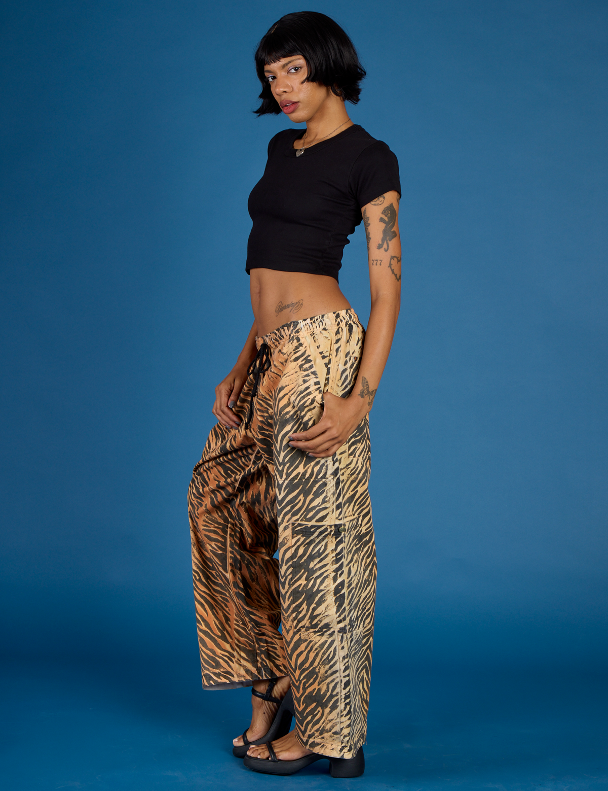 Angled side view of the Tiger Drop Pocket Pant on Kira
