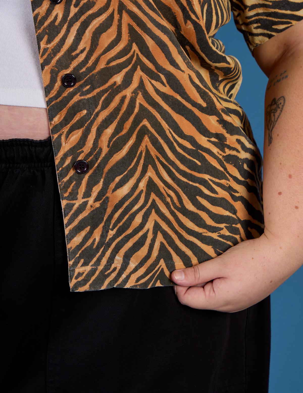 Close up on the buttons and hem of the Tiger Pantry Button Up