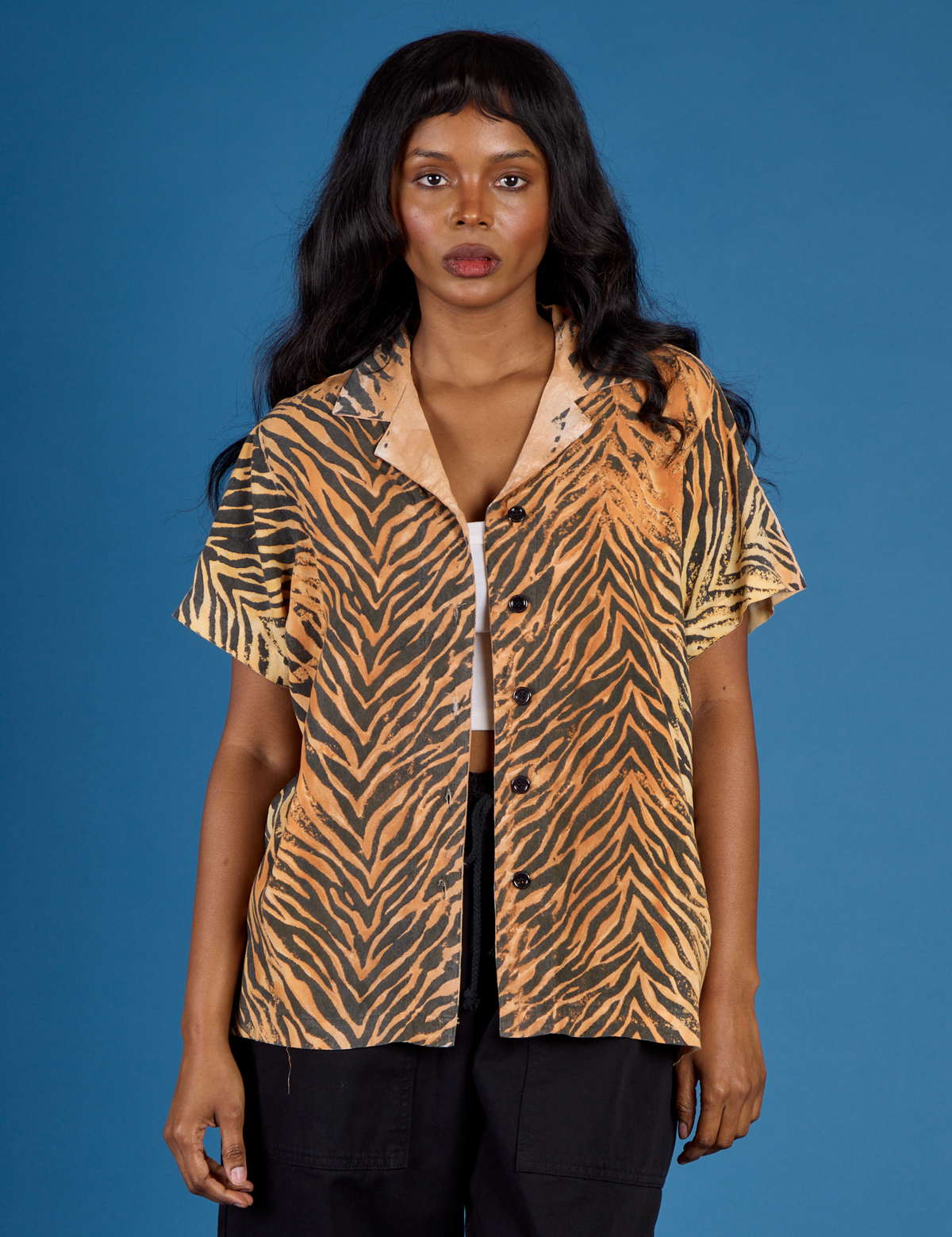 Kandia is wearing the Tiger Pantry Button Up
