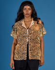 Kandia is wearing the Tiger Pantry Button Up