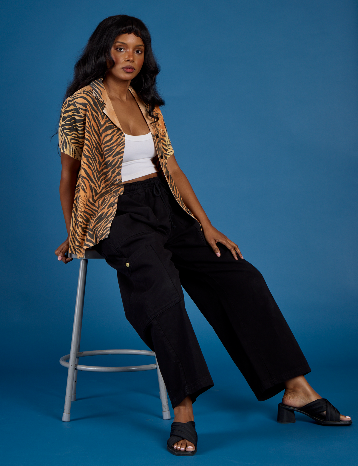Kandia wearing the Tiger Pantry Button Up open with the Vintage Tee White Cropped Tank and Black Drop Pocket Pants