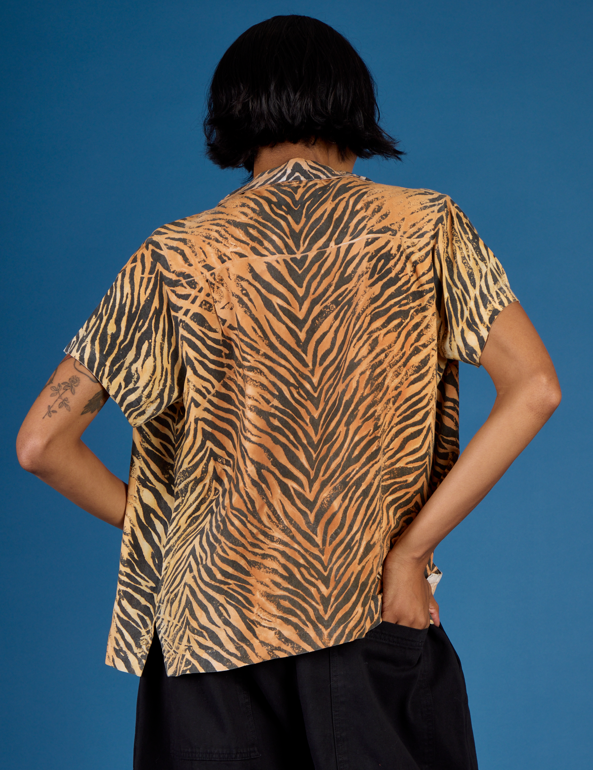 Back view of Kira wearing the Tiger Pantry Button Up
