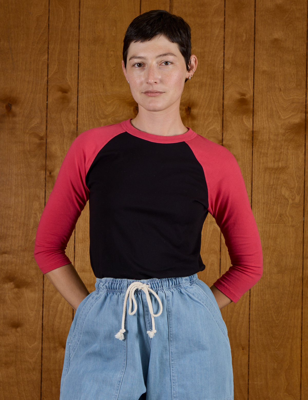 Alex wearing the Black/Pink Colorblock Raglan Tee tucked in