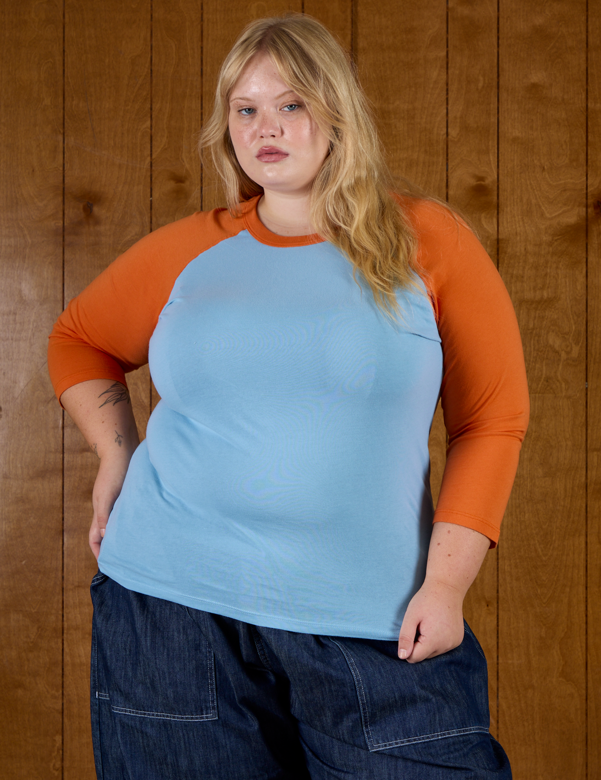 Juliet is 5'7" and wearing L Baby Blue/Orange Colorblock Raglan Tee
