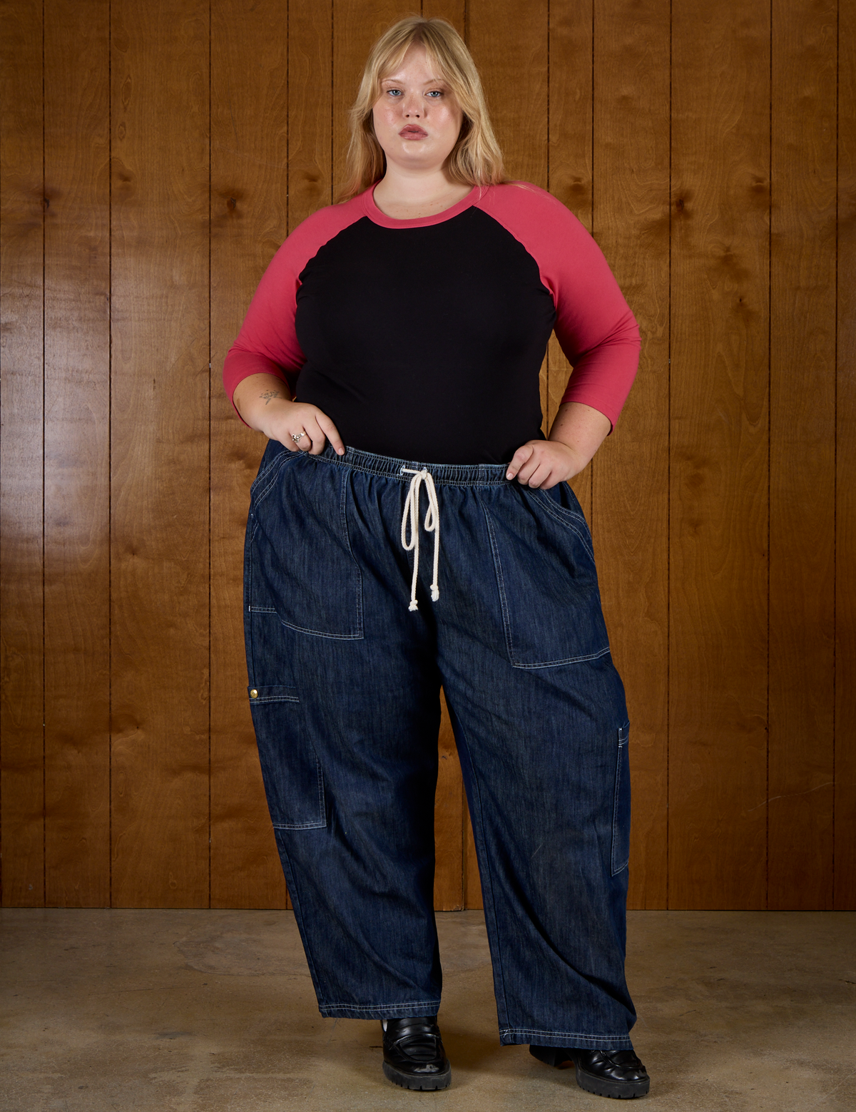 Juliet in the Black/Pink Colorblock Raglan Tee tucked into the Dark Wash Denim Drop Pocket Pants