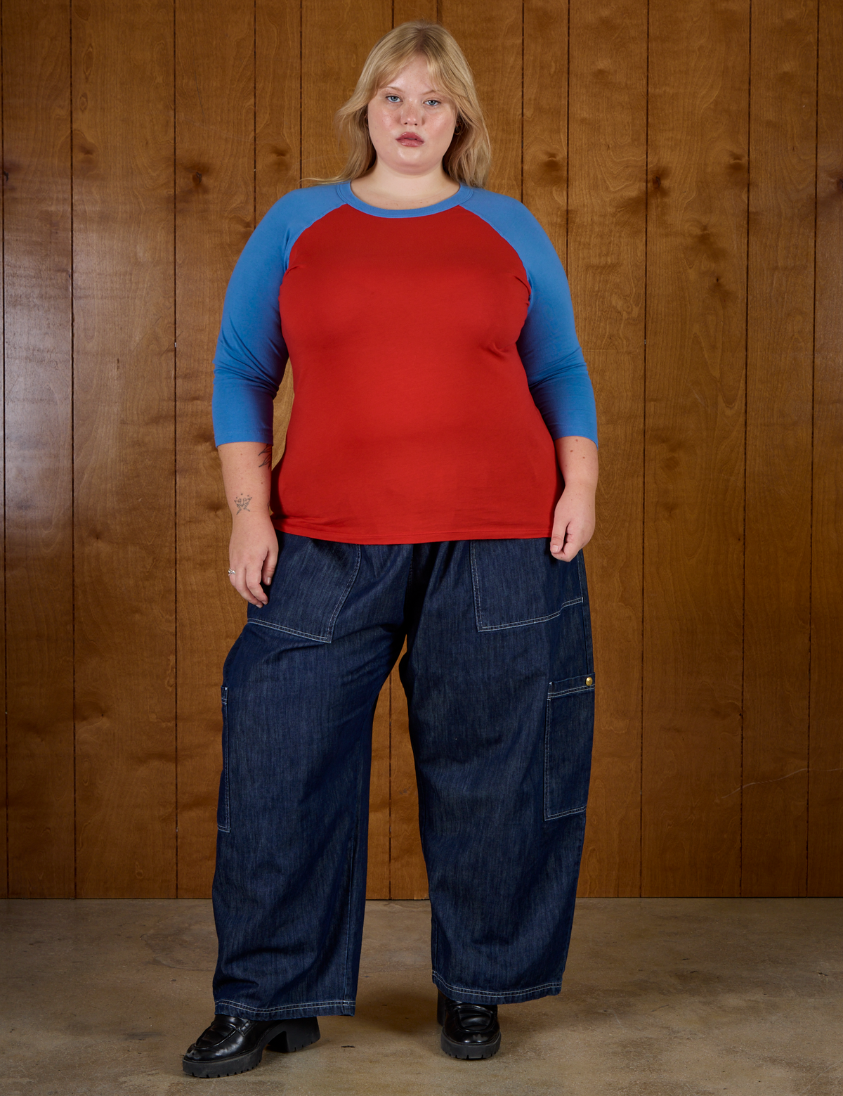 Juliet wearing the Mustang Red/Blue Colorblock Raglan Tee with Dark Wash Drop Pocket Pants