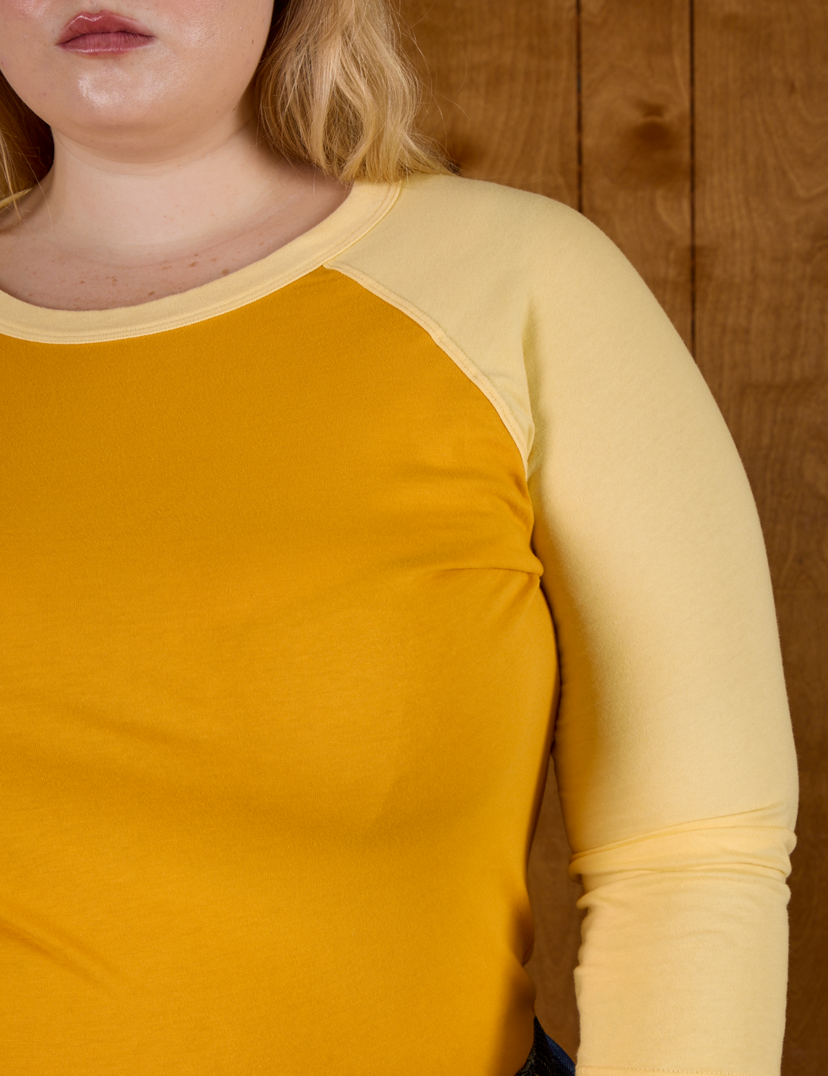 Close up of the Mustard Yellow/Butter Raglan Tee on Juliet