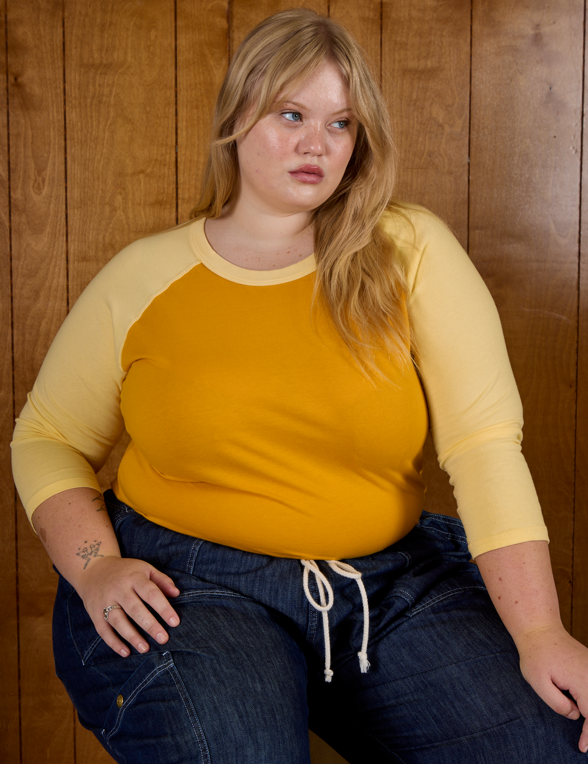 Juliet is 5'7" and wearing L Mustard Yellow/Butter Raglan Tee 