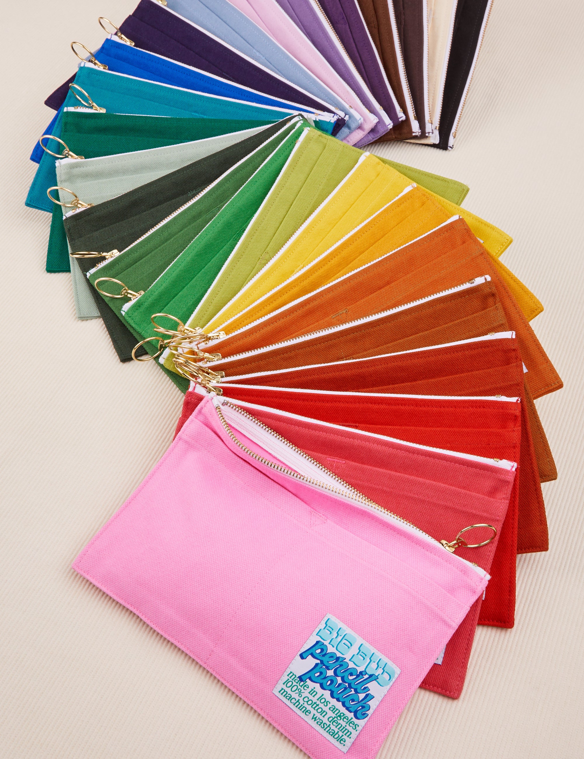 Pencil Pouch in an array of colors fanned out on a table