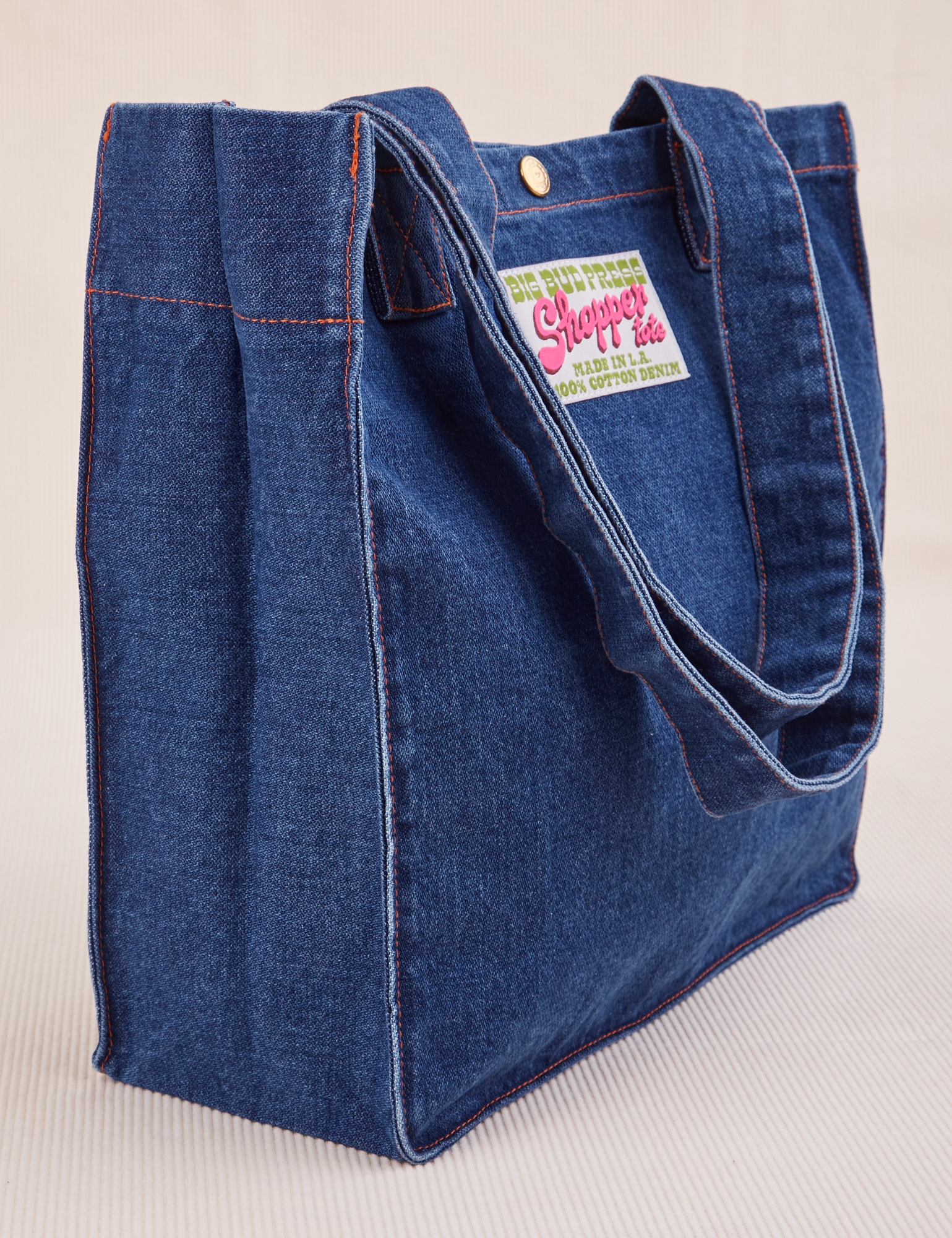 Angled view of Denim Shopper Tote Bag in Dark Wash