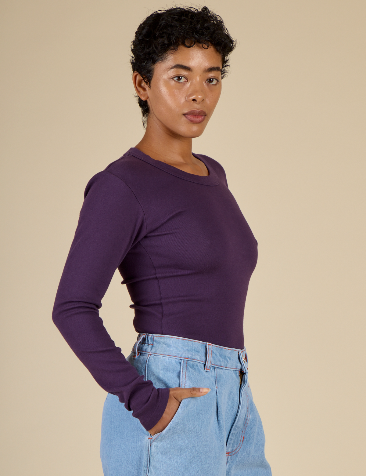 Side angled view of Mika in the Nebula Long Sleeve Baby Tee