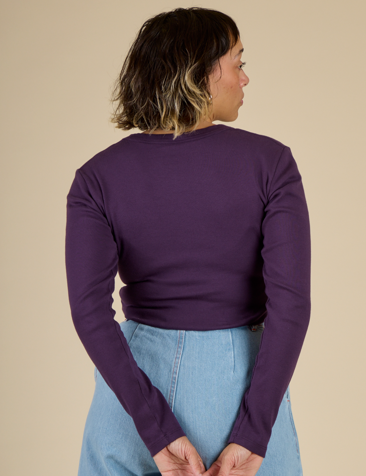 Back view of the Nebula Long Sleeve Baby Tee on Tiara