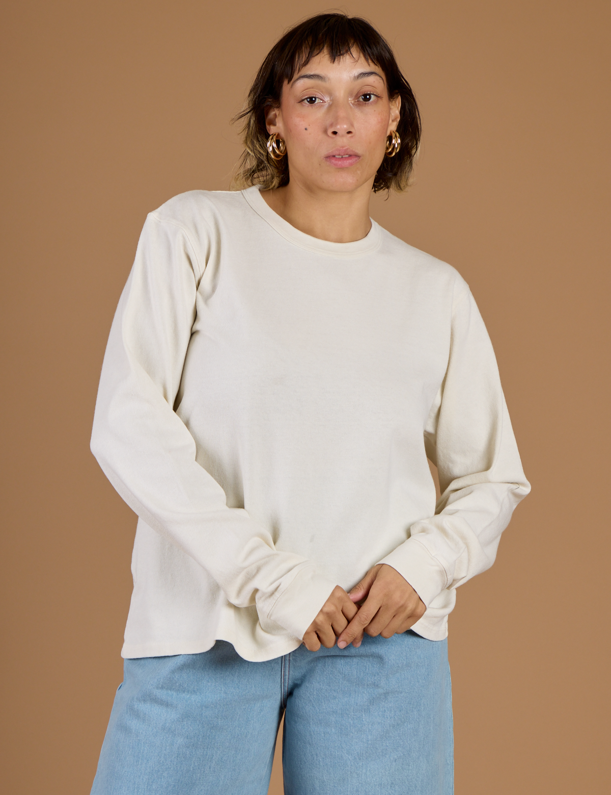 Tiara is 5'4 and wearing XS Vintage Tee White Long Sleeve Burly Tee