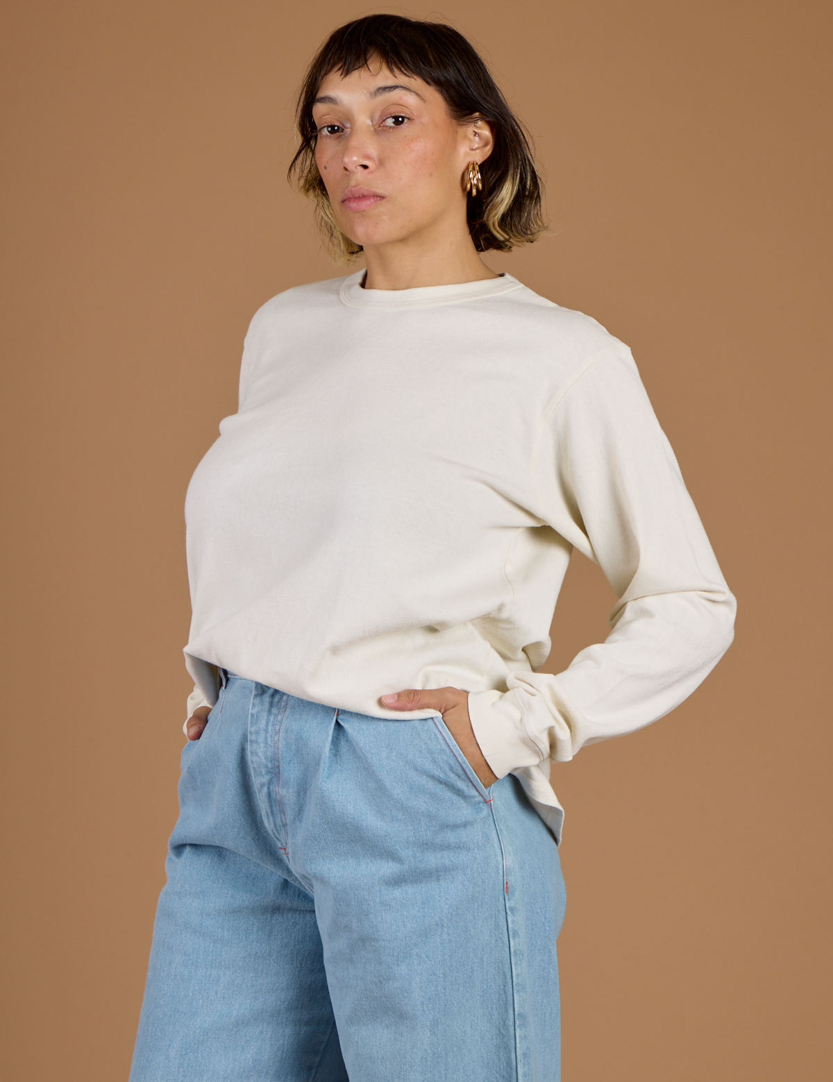 Angled side view of Tiara wearing the Vintage Tee White Long Sleeve Burly Tee 