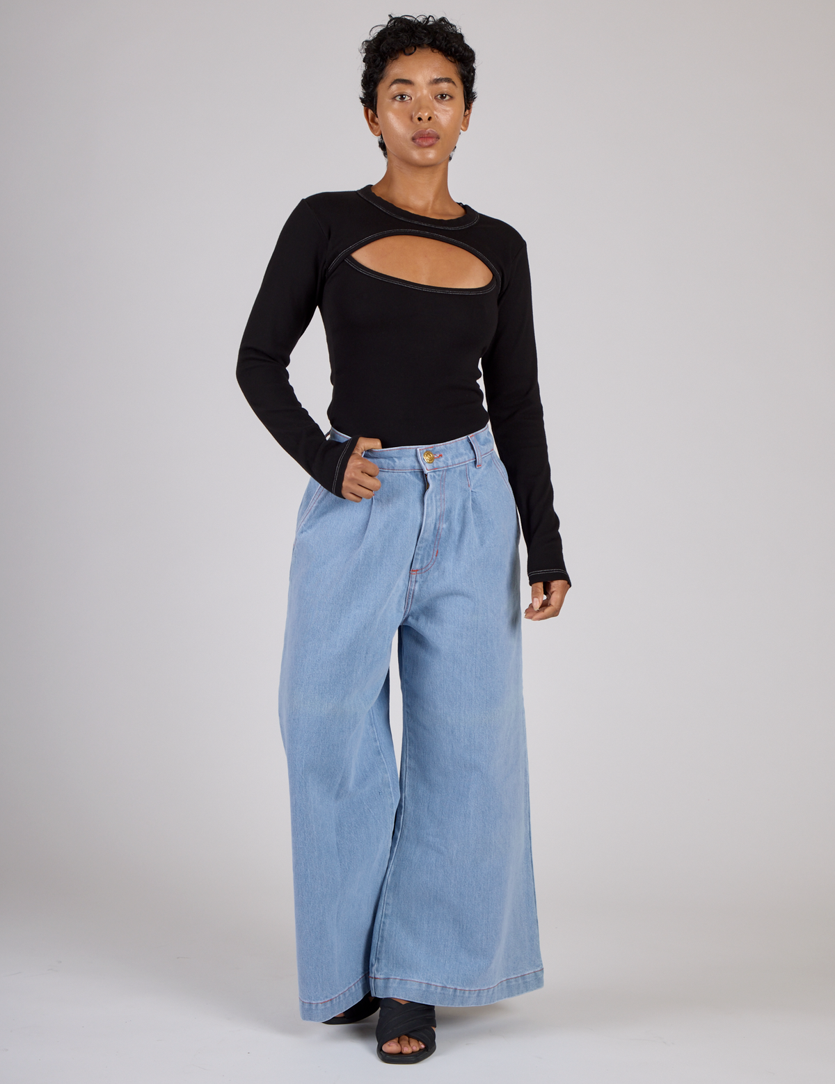 Mika wearing the Black Porthole Long Sleeve Tee with Petite Light Wash Wide Leg Denim Trousers