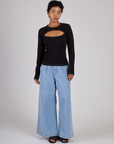 Mika wearing the Black Porthole Long Sleeve Tee with Petite Light Wash Denim Trousers