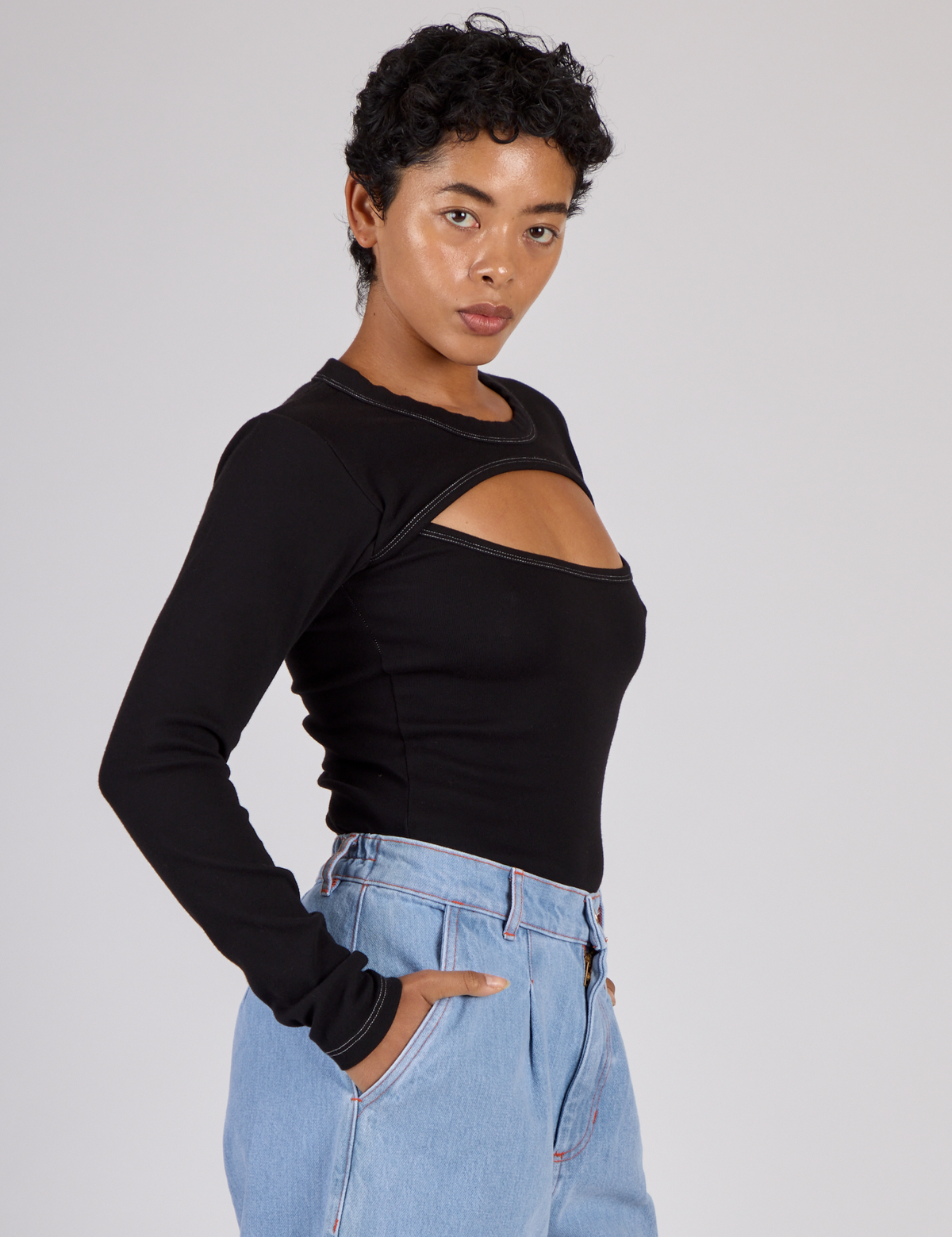 Side view of Mika wearing the Black Porthole Long Sleeve Tee