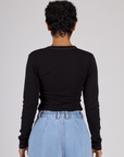 Back view of Mika wearing the Black Porthole Long Sleeve Tee