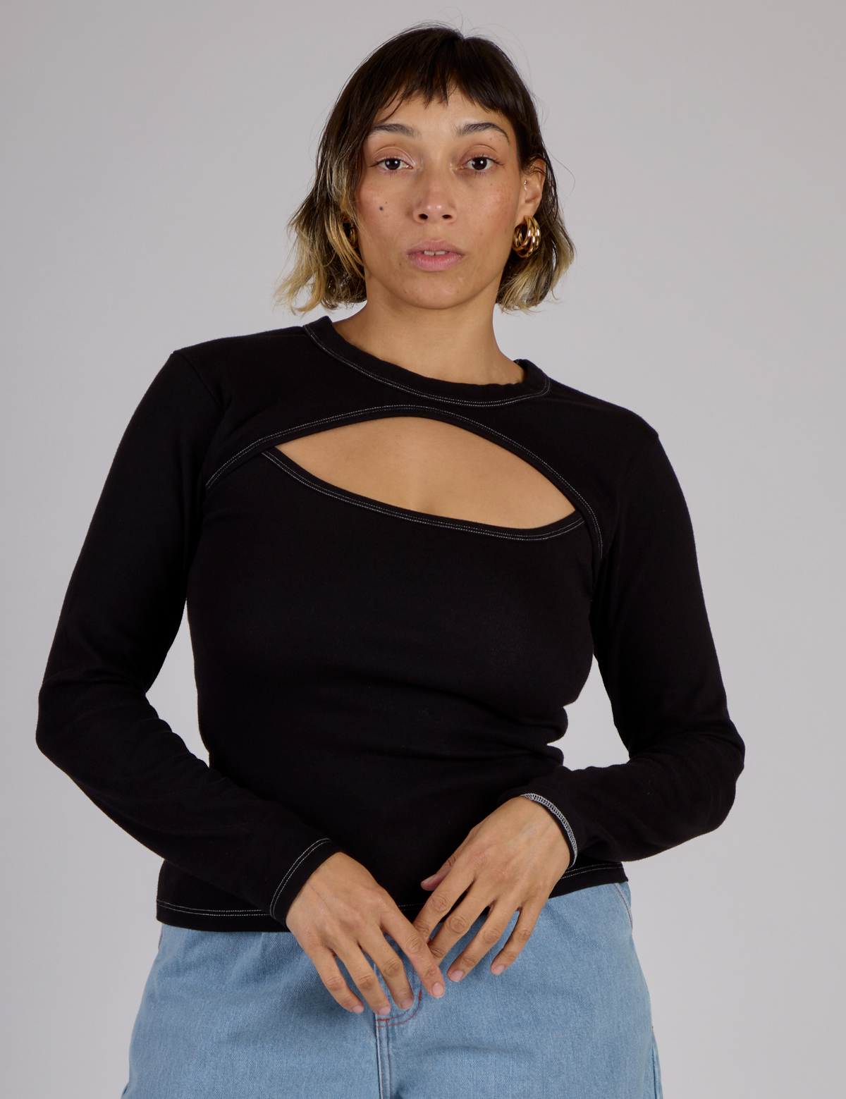 Tiara is 5'4" and wearing XS Black Porthole Long Sleeve Tee