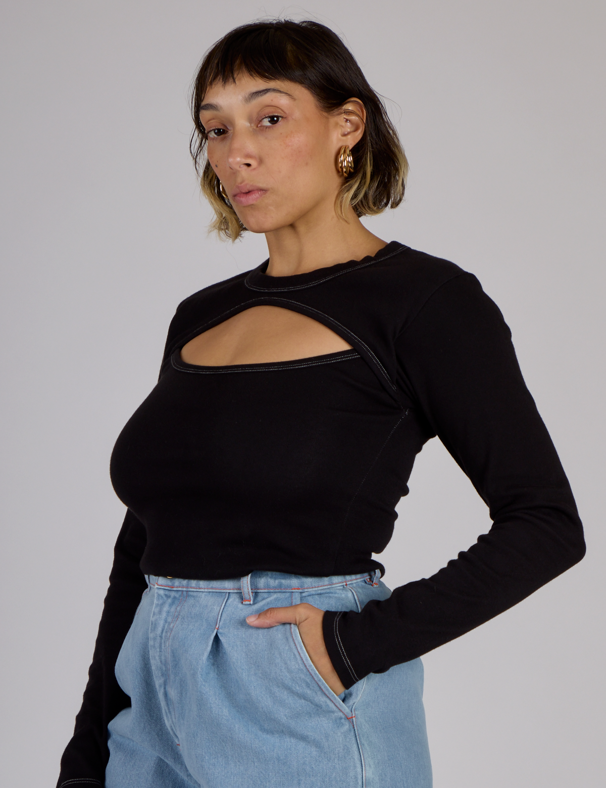 Angled side view of Tiara wearing the Black Porthole Long Sleeve Tee