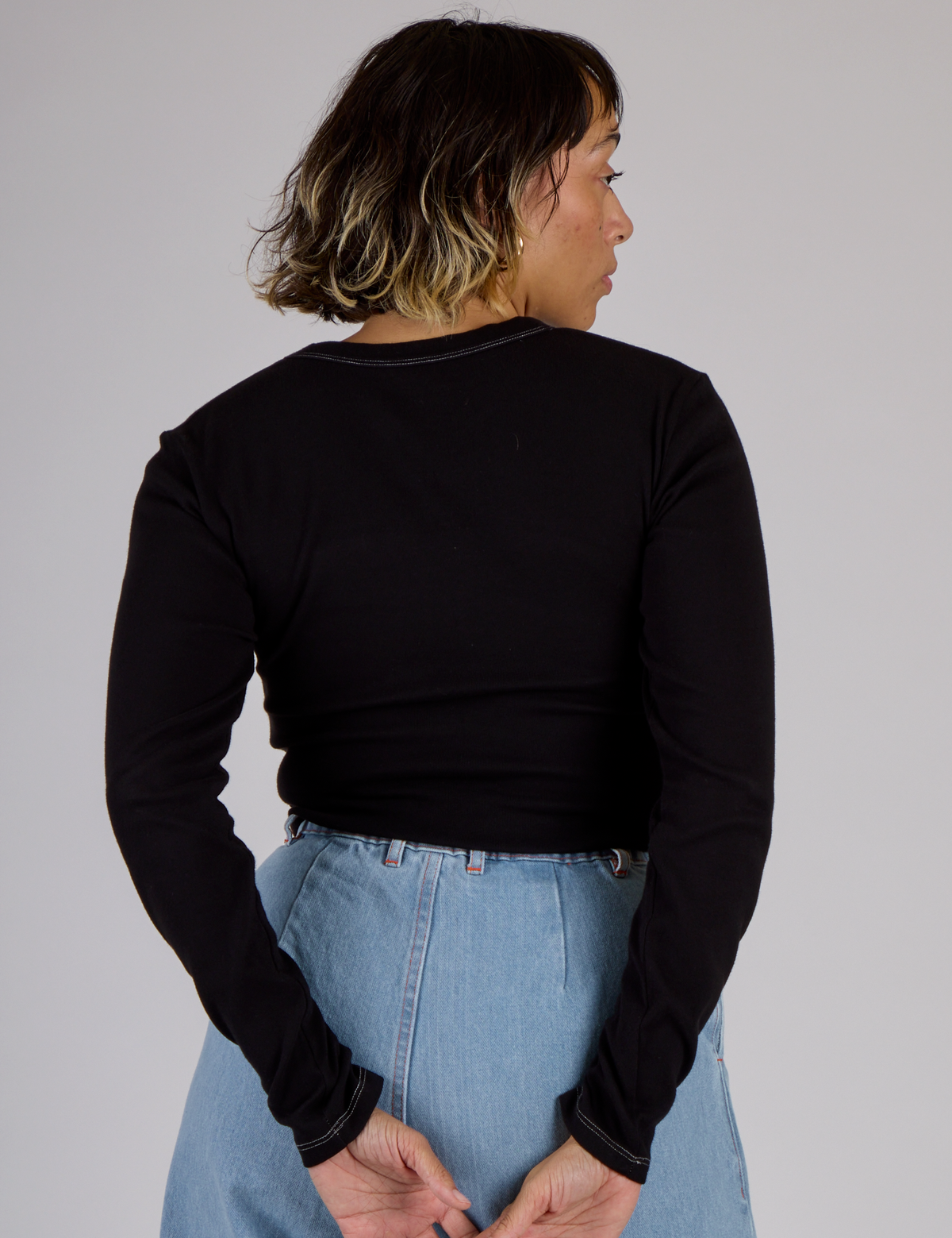 Back view of Tiara wearing the Black Porthole Long Sleeve Tee