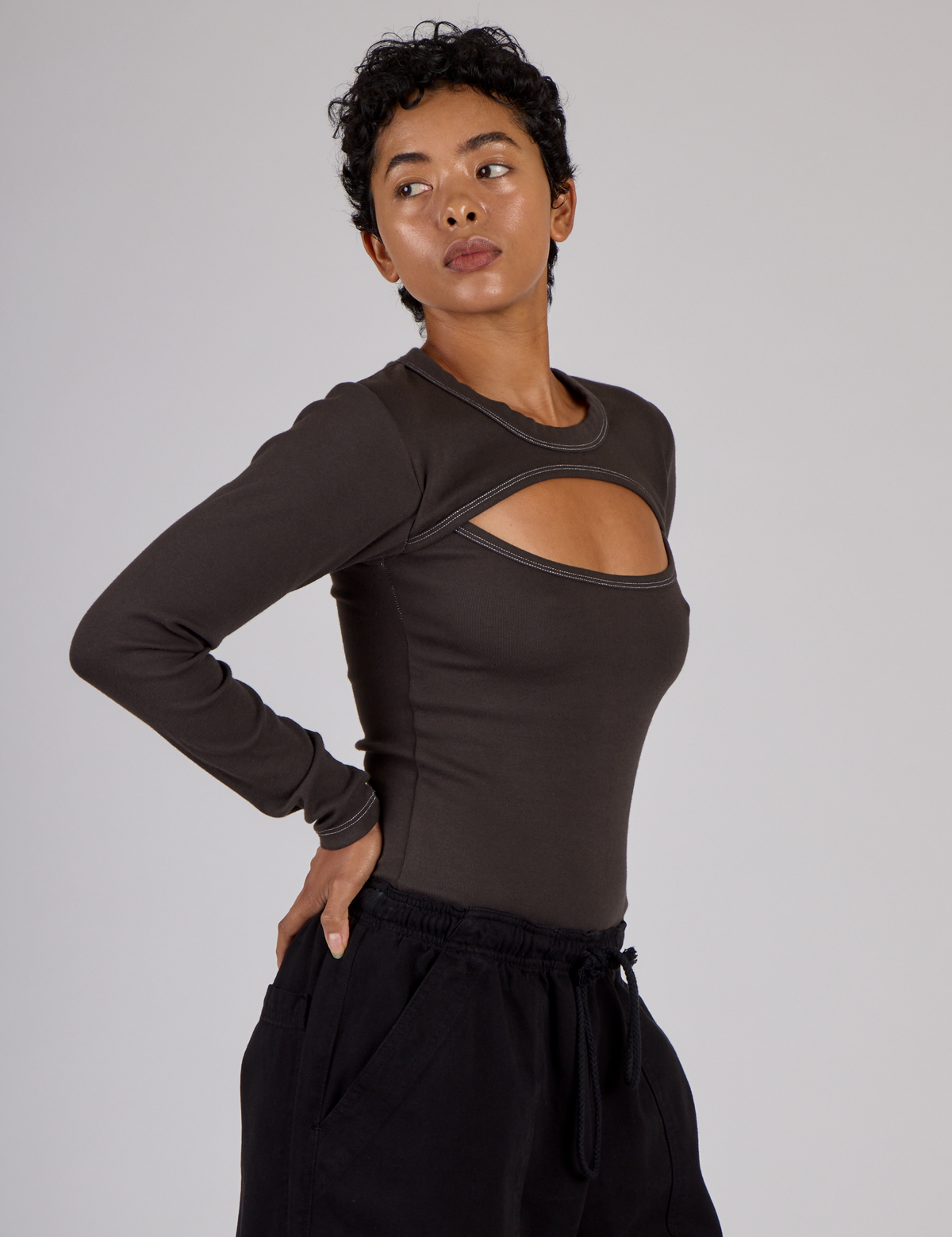 Side view of Mika wearing the Espresso Brown Long Sleeve Porthole Tee