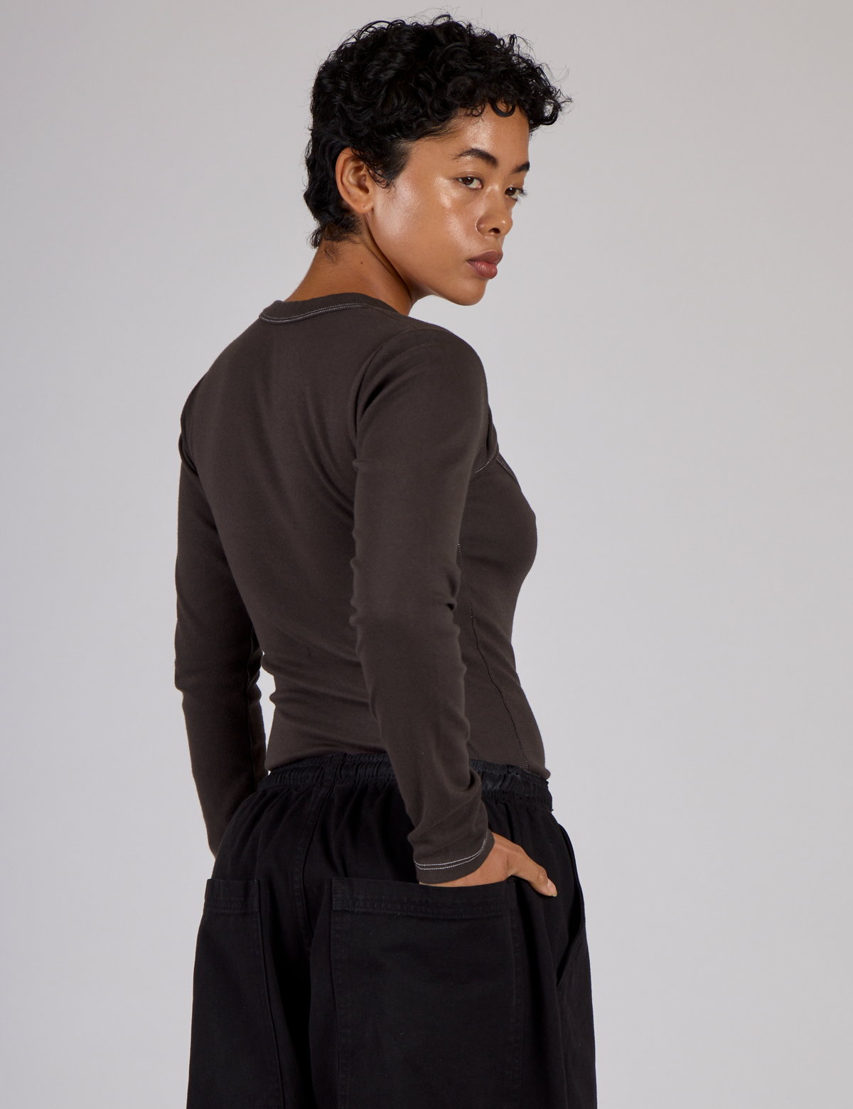 Angels back view of the Espresso Brown Long Sleeve Porthole Tee on Mika