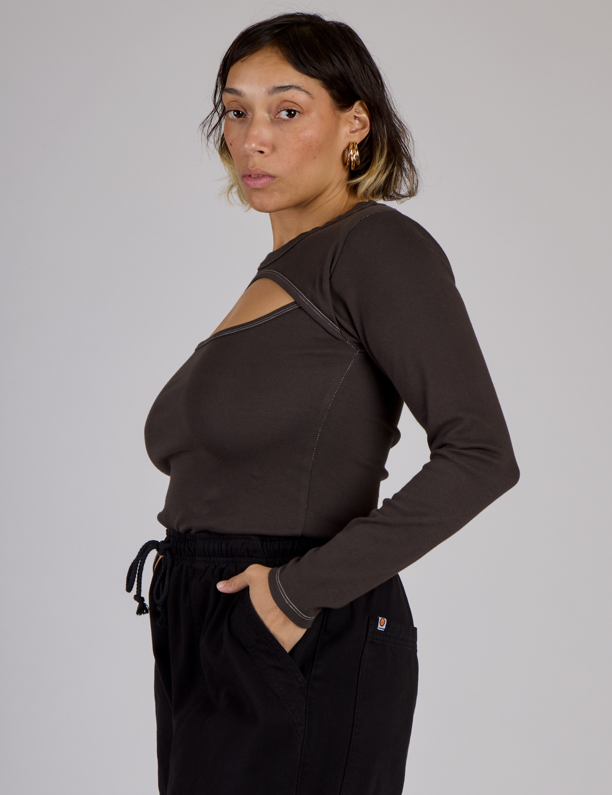 Side view of Tiara wearing the Espresso Brown Long Sleeve Porthole Tee