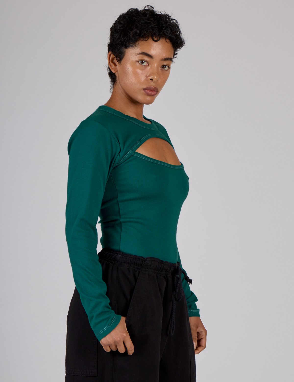 Side view of the Hunter Green Long Sleeve Porthole Tee on Mika