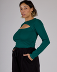 Tiara wearing the Hunter Green Long Sleeve Porthole Tee tucked into Black Drop Pocket Pants