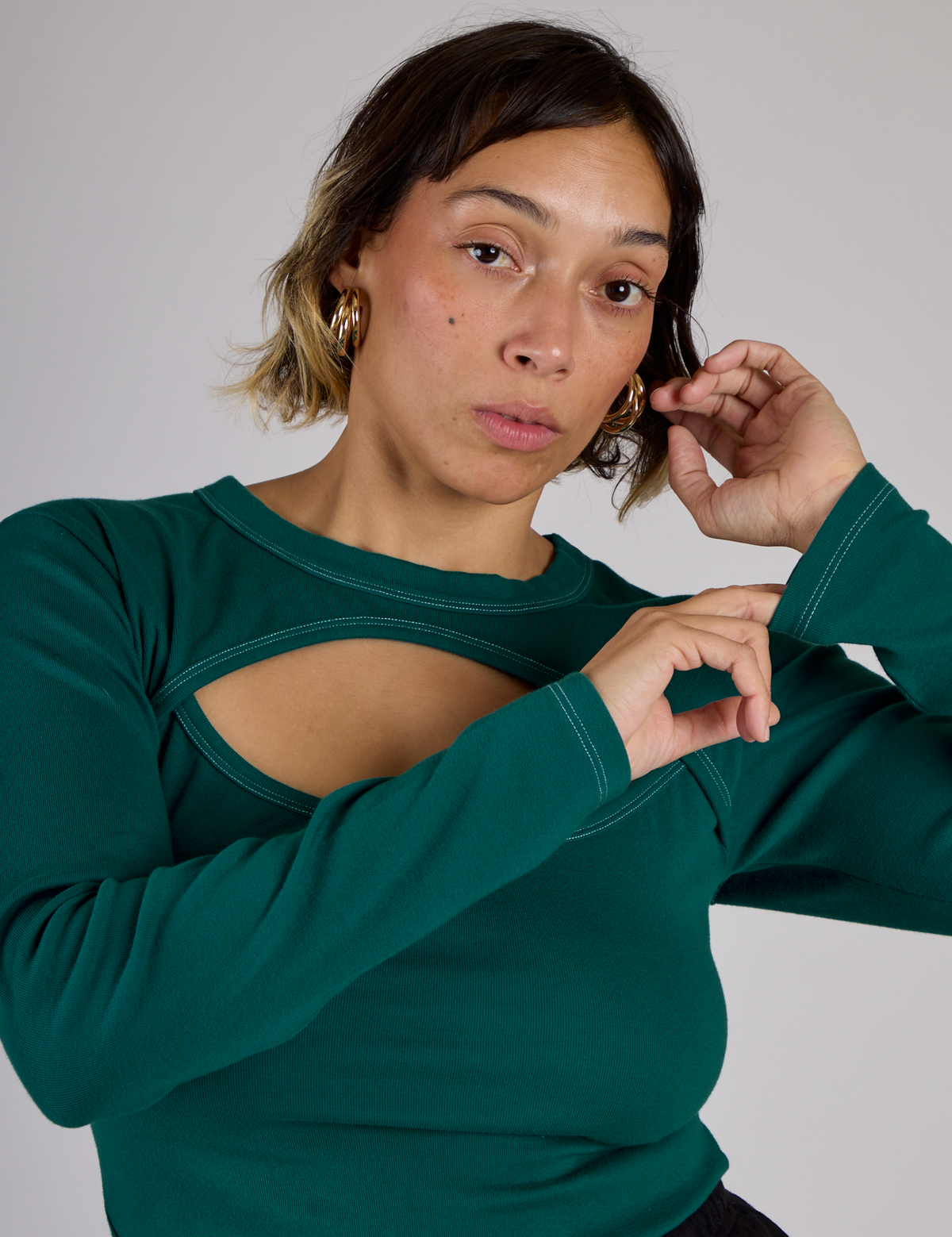 Tiara is 5'4" and wearing XS Hunter Green Long Sleeve Porthole Tee