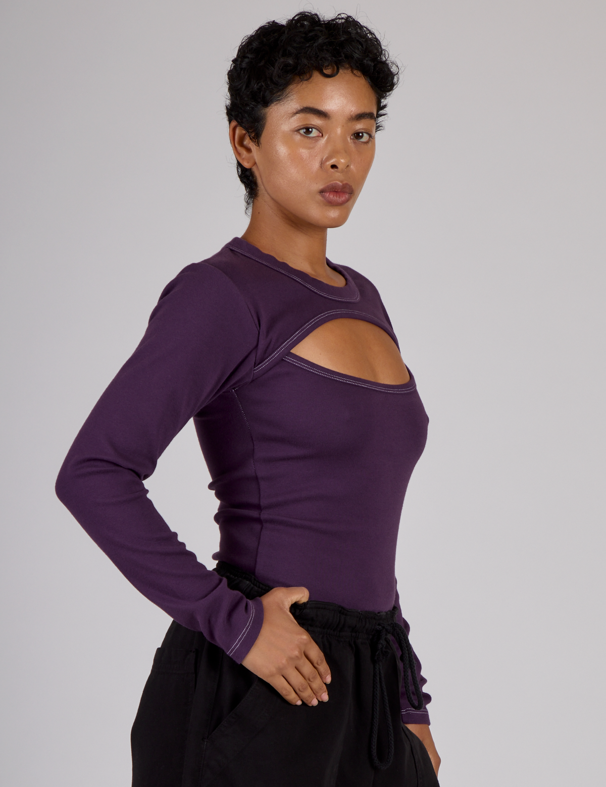Side view of Mika wearing the Nebula Purple Long Sleeve Porthole Tee