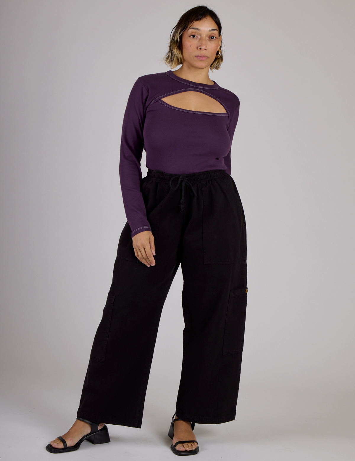 Tiara wearing the Nebula Purple Long Sleeve Porthole Tee tucked into the Black Drop Pocket Pants
