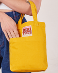 Mini Tote Bag in Mustard Yellow on Alex's arm