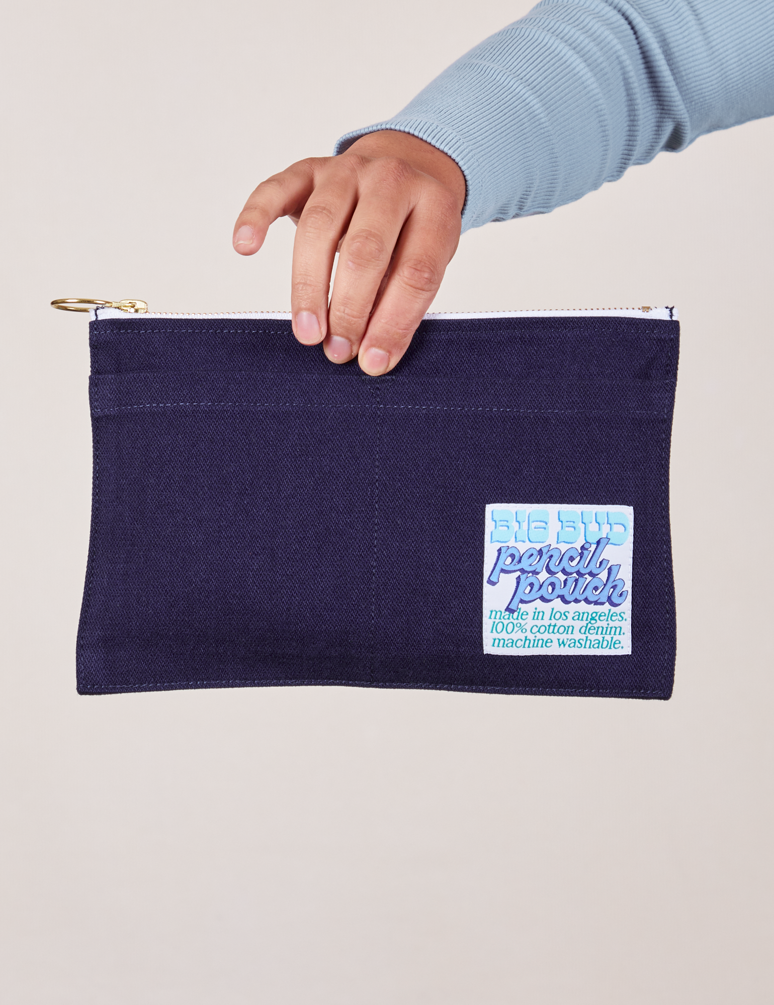 Pencil Pouch in Navy Blue held by model