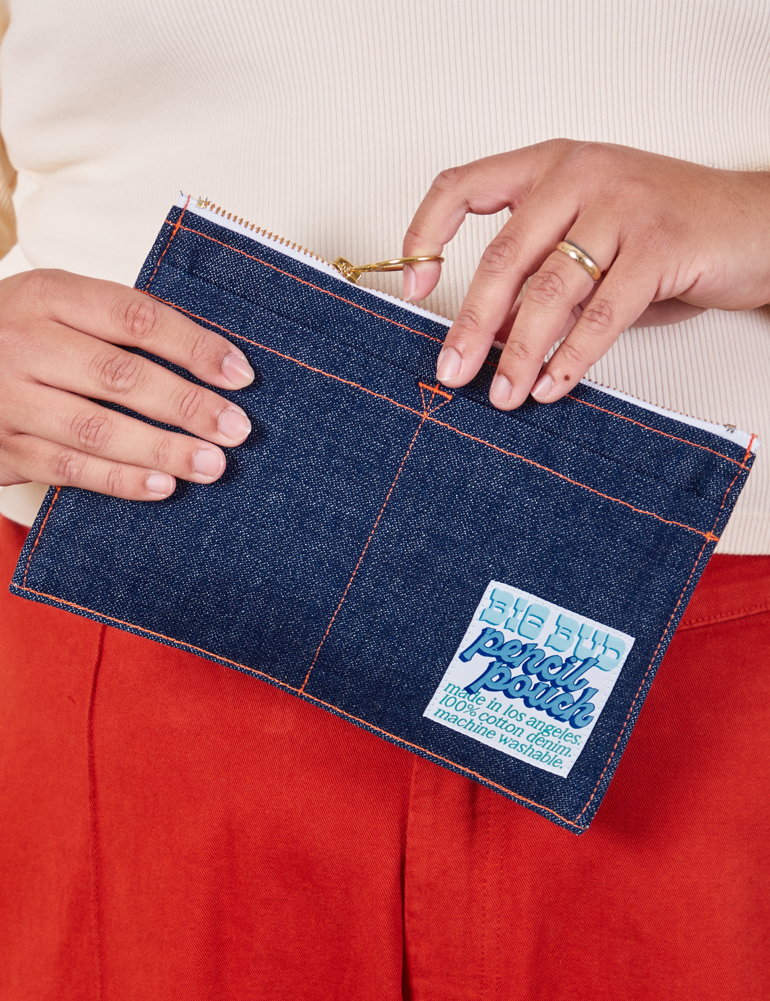 Pencil Pouch in Dark Wash Denim held by model
