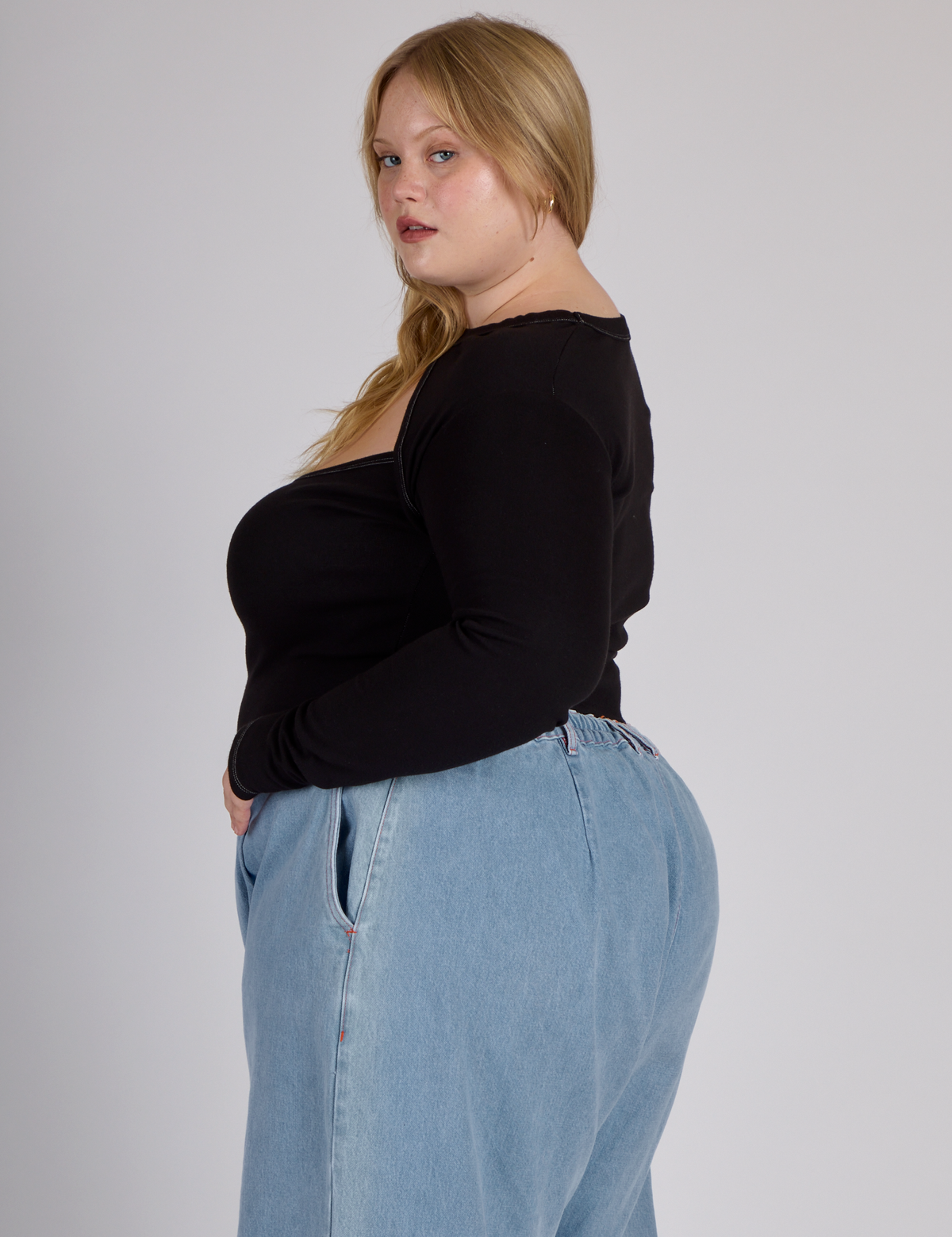 Side view of Juliet wearing the Black Porthole Long Sleeve Tee