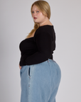Side view of Juliet wearing the Black Porthole Long Sleeve Tee