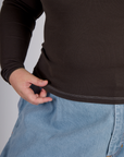 Close up of the Espresso Brown Long Sleeve Porthole Tee's hem worn by Juliet