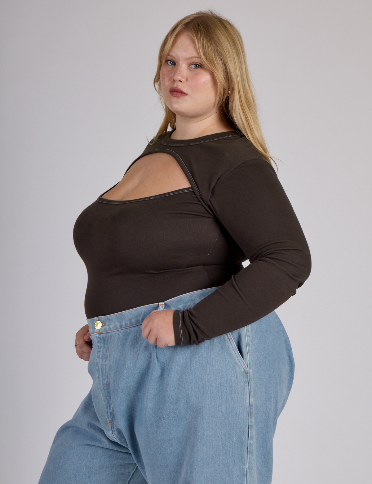 Side view of Juliet wearing the Espresso Brown Long Sleeve Porthole Tee