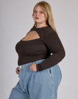 Side view of Juliet wearing the Espresso Brown Long Sleeve Porthole Tee